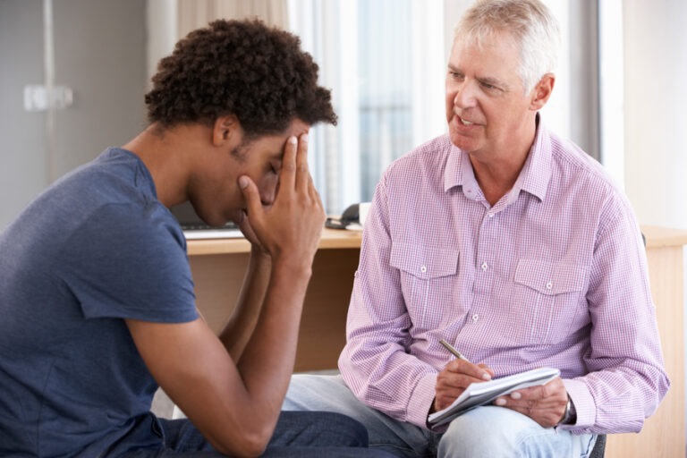 therapist discussing mental health with patient