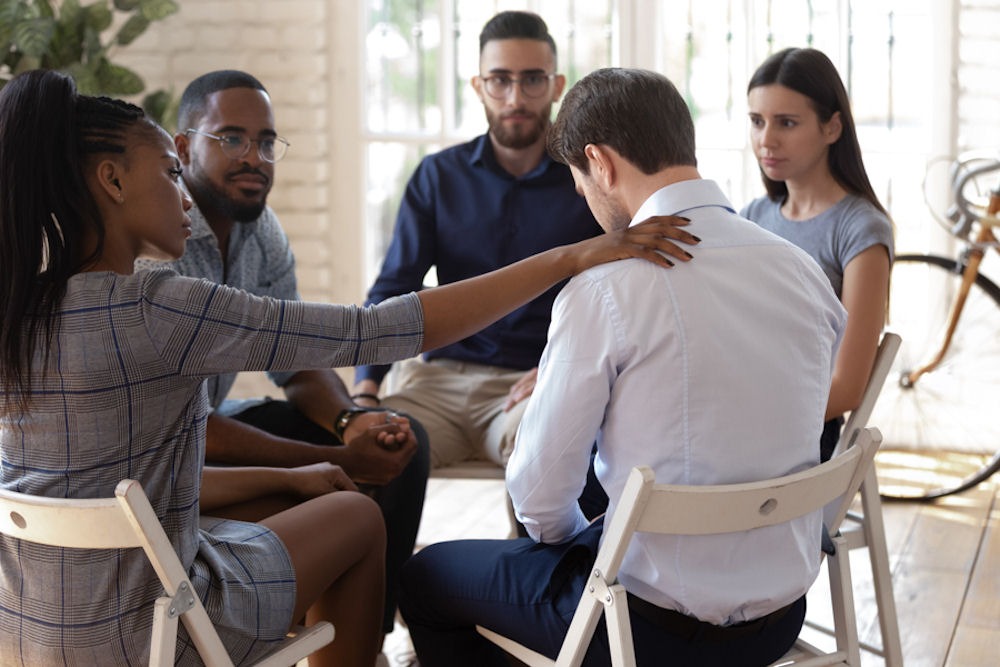 diverse group sitting in meeting for addiction treatment