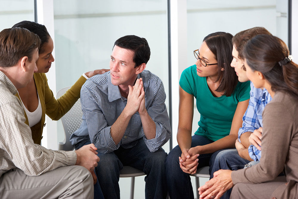  group of adults in therapy for addiction