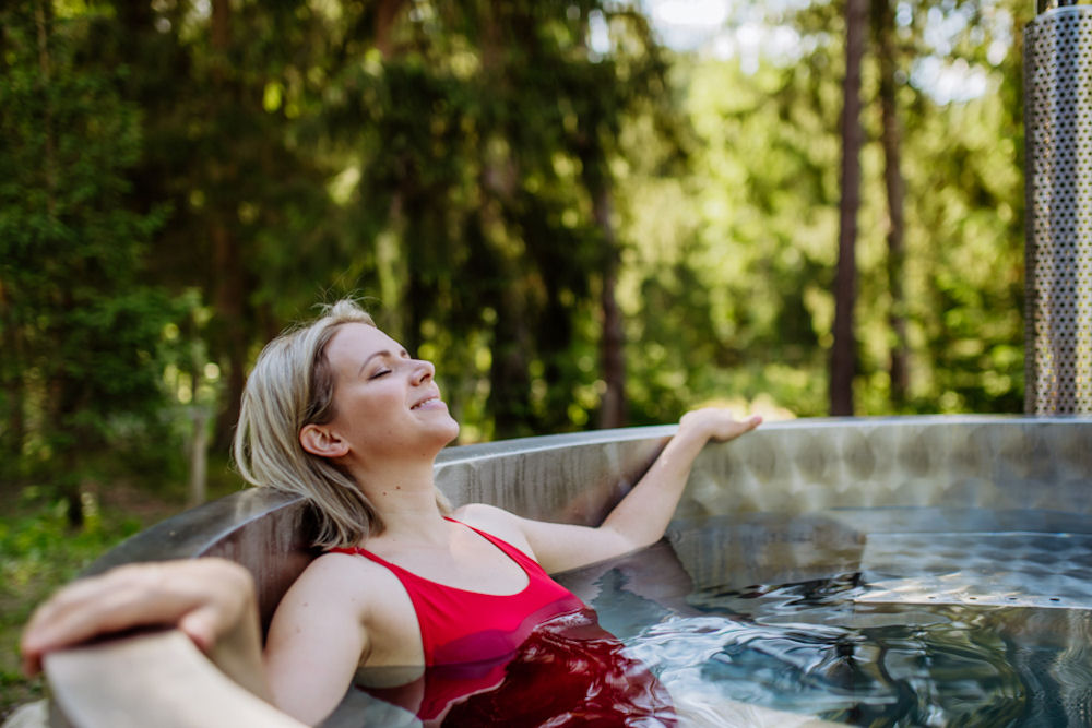 Woman smiling in hot tub with closed eyes