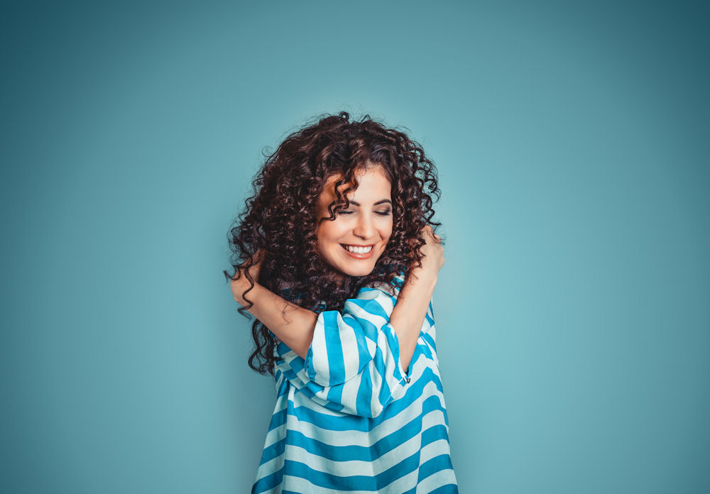 A woman hugging herself and showing good self-care