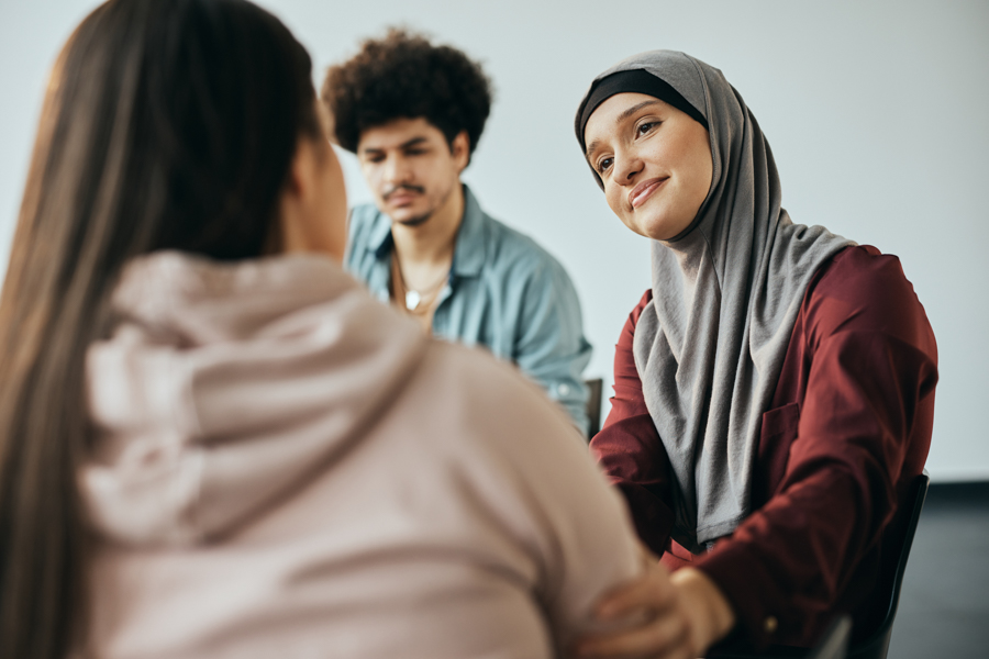 woman comforting another in group therapy