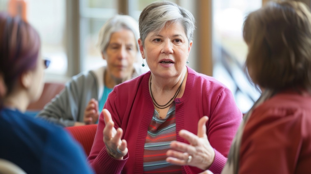 Woman in bright cardigan talking about fentanyl addiction in support group