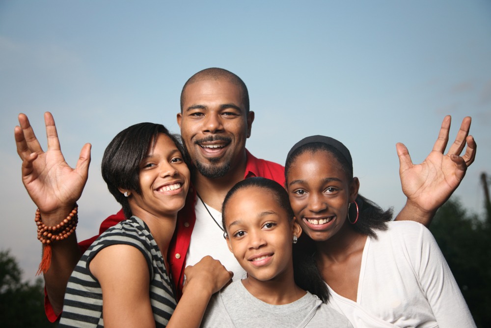 Shot of happy family with father, mother, and two daughters