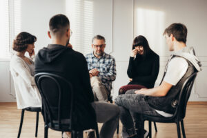 Mixed gender group discussing the most addictive drugs