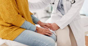 Doctor holding a patient's hand while explaining how long marijuana stays in the body.