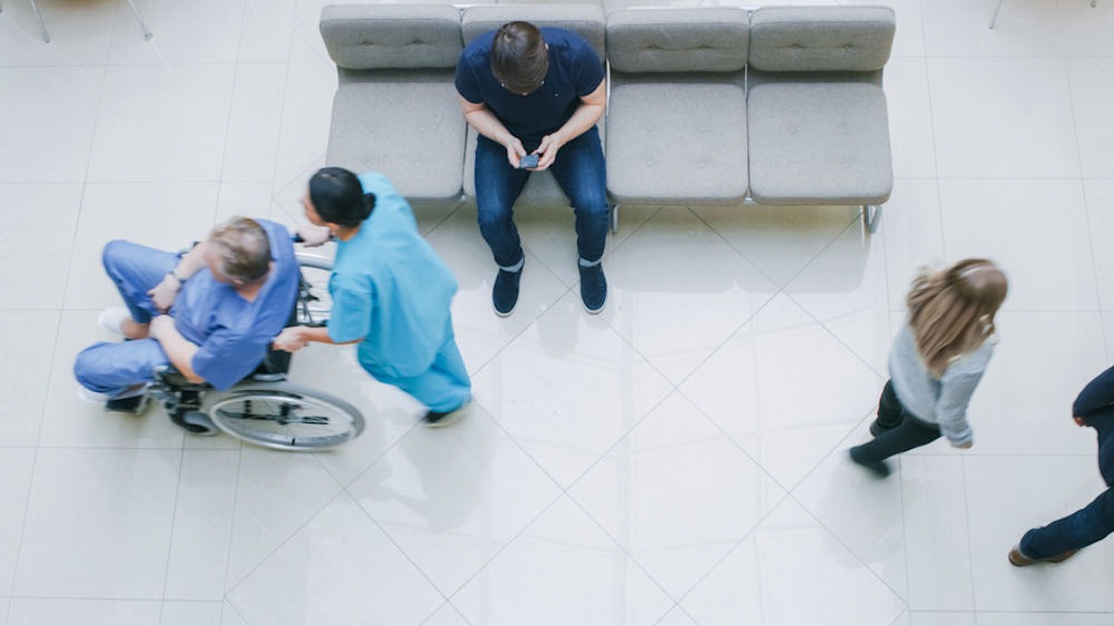 Overhead shot of an emergency room featuring people waiting and nurses